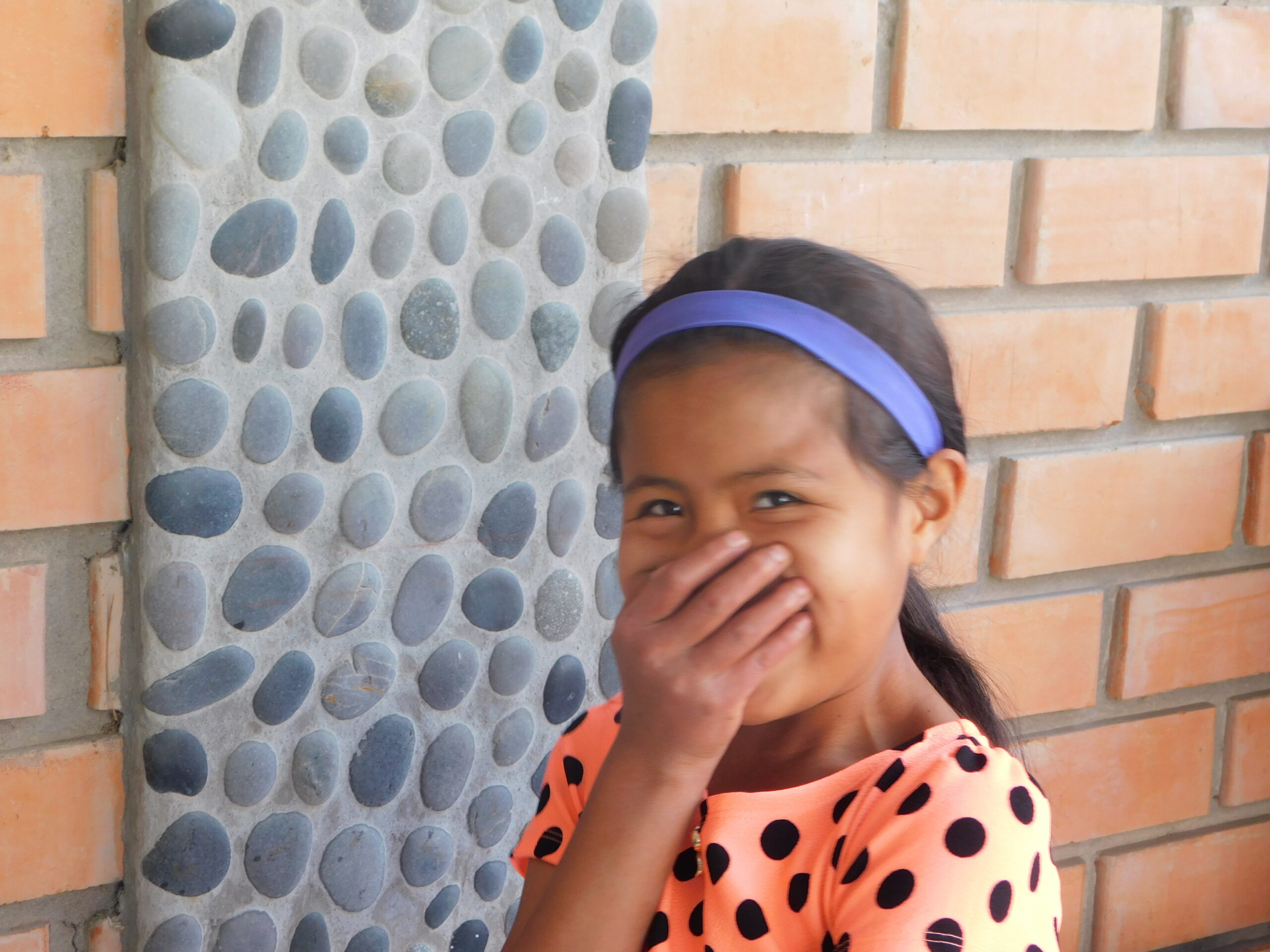 A girl laughing at the Restoring Children International home