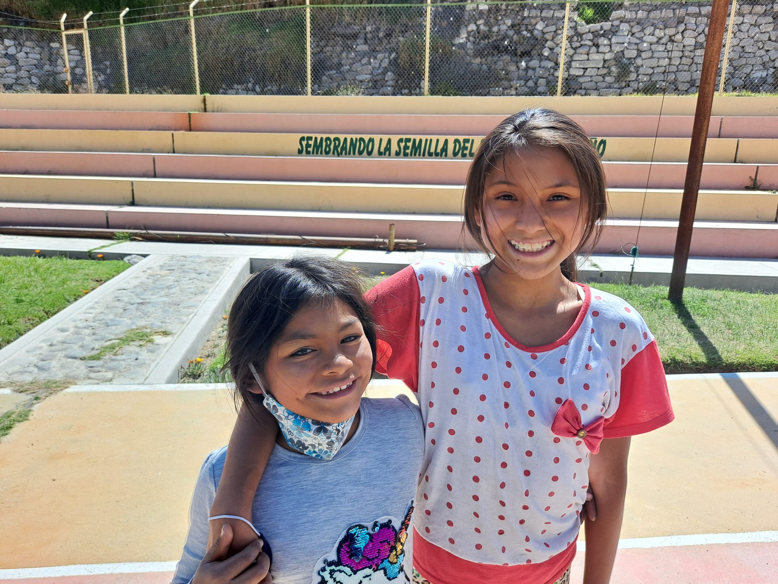 Two girls smiling at the Restoring Children International home