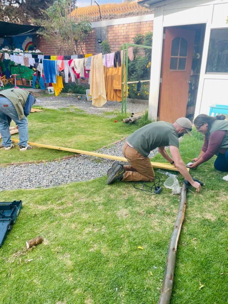 Tim and the team measuring timber for the sukkah frame in the garden of the RCI home