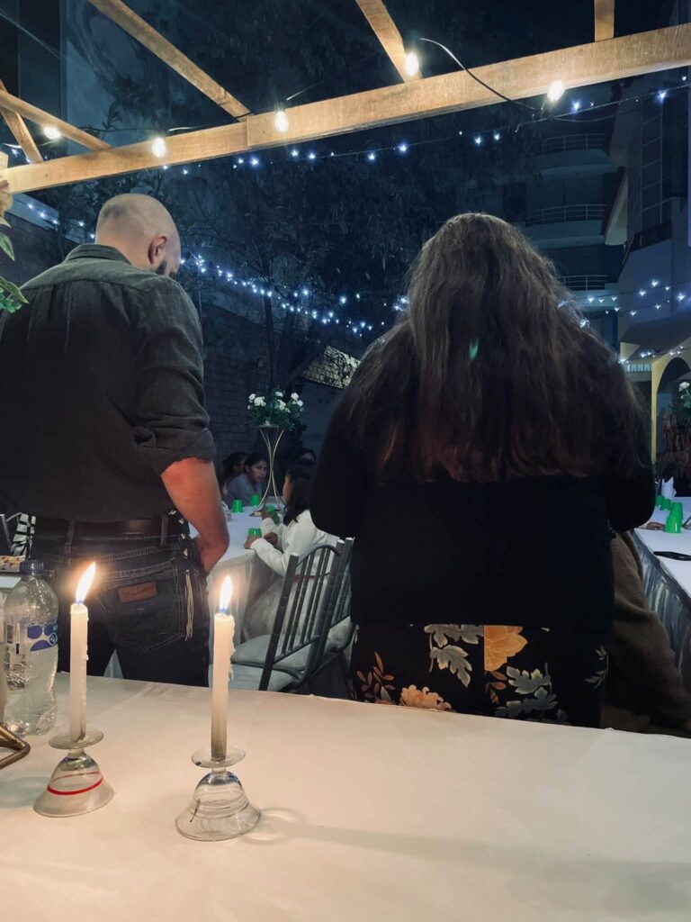 Candles lit at the head table as the evening begins